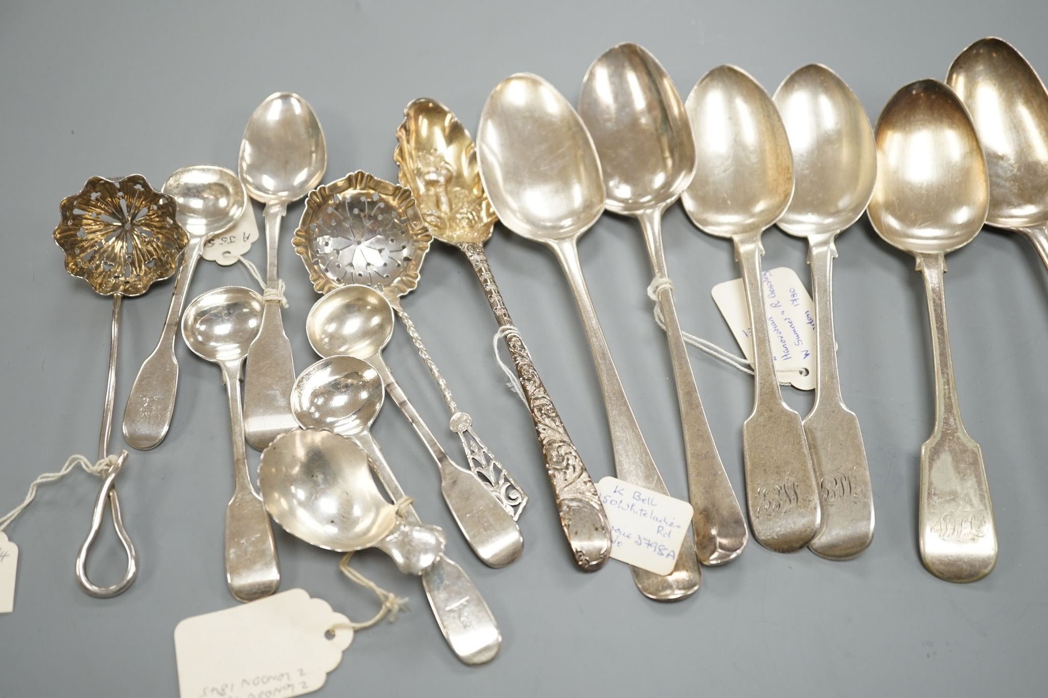 A small collection of 18th century and later silver flatware, including a table spoon by Thomas Eustace, Exeter, 1785, two 18th century silver lace back dessert spoons, an 18th century 'berry' spoon, a George III silver